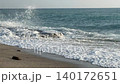 Ocean waves crashing against rocky shoreline on sunny beach, serene nature background video 140172651