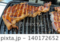 Grilled steak on a barbecue grill with juicy, seared marks, suitable for food backgrounds video 140172652