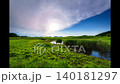 Early summer in the Soni Highlands: Clouds crossing the evening sky and the faint surface of Okame Pond. 140181297