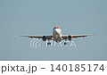 Passenger airplane approaches airport runway for landing during a clear day, showcasing the excitement of air travel arrivals 140185174