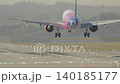 Airplane landing approach over runway during delayed flight at airport under clear skies 140185177