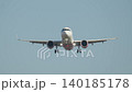 Landing approach of passenger aircraft at a busy airport during daylight 140185178