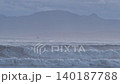 After the typhoon has passed, huge waves crash against the Shonan coast as dusk approaches. Hakone and Mount Kintoki are in the background. 140187788