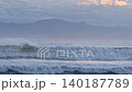 After the typhoon has passed, huge waves crash against the Shonan coast as dusk approaches. Hakone and Mount Kintoki are in the background. 140187789