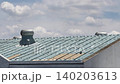4K Roof ventilator fans spinning on metal rooftop under cloudy sky 140203613