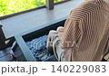 A woman enjoying a footbath while admiring the spectacular view. 140229083