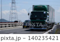 Trucks and cars driving on a national highway; cars; trucks; national highway; traffic; transport; movement; carrying; driving; business; road 140235421