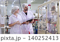 Two technician inspecting automated machinery in food industry. 140252413