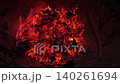 Smoldering embers glow in close-up after a campfire 140261694