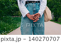 Casual walk in the park during spring with a focus on a woman's outfit and surroundings 140270707