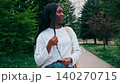 Smiling woman walking in a park wearing casual clothes on a sunny day in spring 140270715