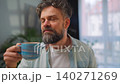 Happy man drinking coffee at relaxed home environment closeup. 140271269