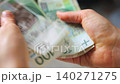 Female hands carefully counting polish zloty banknotes 140271275