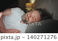 A man lying in bed using smartphone late at night 140271276