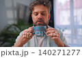Happy man drinking coffee at relaxed home environment closeup. 140271277