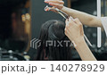 Barber Cutting Long Hair in Modern Salon 140278929