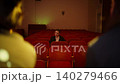Solitary audience member sitting alone in empty theater with red seats during intimate rehearsal or 140279466