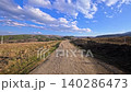 Dirt Road Trail Through Hills in Bulgarian Countryside at Sunset, Scenic Nature Landscape With Blue Sky and Rural Path, Mountain Meadow Panorama in Bulgaria, Outdoor Travel Destination, Peaceful 140286473
