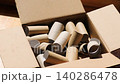 Cardboard toilet paper rolls falling into box, recycling and eco concept, kraft paper tubes for seedling pots, gardening and planting use, sustainable zero waste lifestyle, reuse materials for garden 140286478