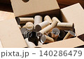 Cardboard toilet paper rolls falling into box, recycling and eco concept, kraft paper tubes for seedling pots, gardening and planting use, sustainable zero waste lifestyle, reuse materials for garden 140286479