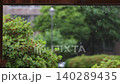 Raindrops falling under the roof eaves and the scenery of rain, rain falling on a green garden and relaxing rain sounds ASMR 140289435