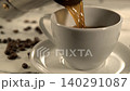 Hot coffee being poured into a white cup with beans on a light table 140291087