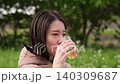 Close-up slow motion of a woman drinking tea at a picnic. 140309687