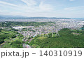 Wide aerial panorama overlooking Odawara City, surrounding forests and hills, with Sagami Bay visible in the distance in Kanagawa, Japan. 140310919