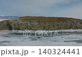 Winter aerial view of Kharantsy Island rocky coast on frozen Lake Baikal 140324441