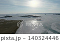 Aerial view of frozen Lake Baikal shoreline with islands and winter sunlight 140324446