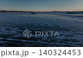 Winter sunset over frozen Lake Baikal ice with cracks and tracks, Baikal 140324453