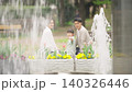 A family watching the fountain in the park 140326446