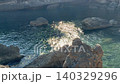 Sea and rocks in secluded cove. 140329296