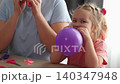 Woman and little girl working together on craft projects and balloon play at home. Family interaction and creative learning concept 140347948