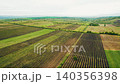 Drone flying above green vineyards and agricultural fields 140356398