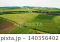 Georgian flag waving over green countryside fields 140356402