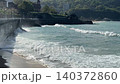 Ocean Waves on San Sebastian Beach with Promenade Seawall Villa and Green Hills 140372860