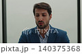 Portrait of young Hispanic manager talks and listens on video call in office. Confident Latin American businessman conducts online conference from workspace 140375368