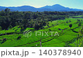 Beautiful morning view in Indonesia, panoramic landscape of rice fields with mountain ranges and clear sky 140378940