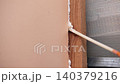 Applying thermal insulation foam with a gun. Using polyurethane foam along wall joints. Expanding the material. Sealing joints and soundproofing walls. Interior renovation. Close-up. Copy space. 140379216