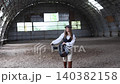 Young woman posing holding equestrian horse saddle 140382158