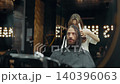 Barber Cutting Long Hair in Modern Salon 140396063