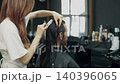 Barber Cutting Long Hair in Modern Salon 140396065
