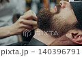 Barber Applying Talcum Powder On Client Beard 140396791