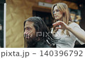 Barber Cutting Long Hair in Modern Salon 140396792