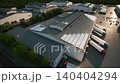 Industrial Warehouse with Expanding Solar Panel Installation - Aerial Logistics Center at Sunset. Rooftop Solar Panel Installation on Industrial Warehouse 140404294