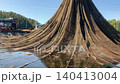 Crane lifting aquaculture net at fish farm 140413004