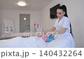 Professional esthetician performing facial massage treatment 140432264