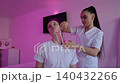 Esthetician applying kinesiology tape for face lifting 140432266