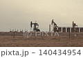 Oil pumpjacks extracting crude oil in a field 140434954